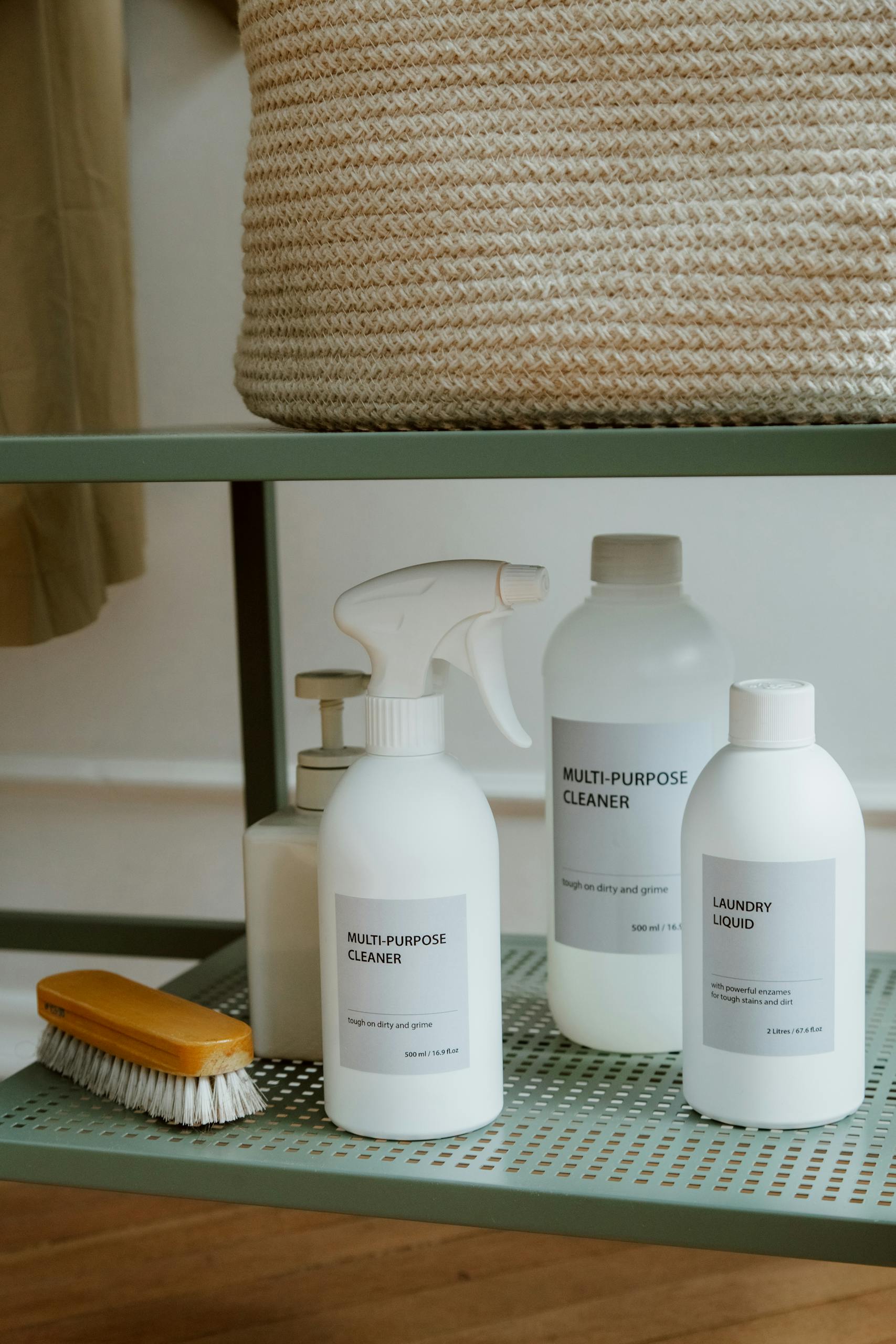 A neatly arranged collection of cleaning supplies on a metal shelf.