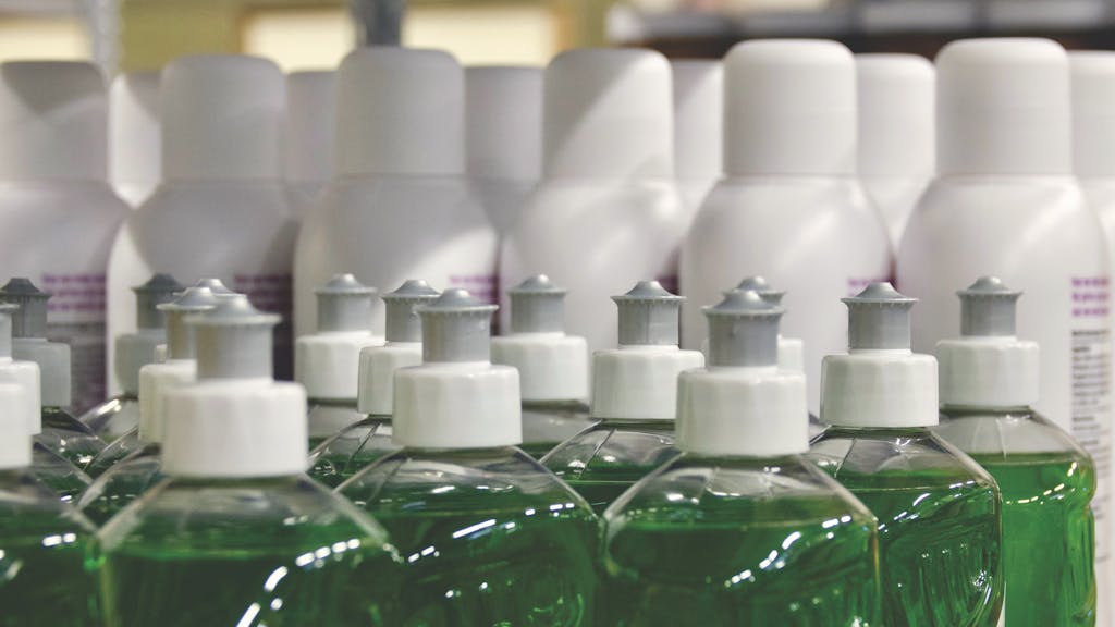Close-up view of green liquid in bottles, ideal for household cleaning and stocks.