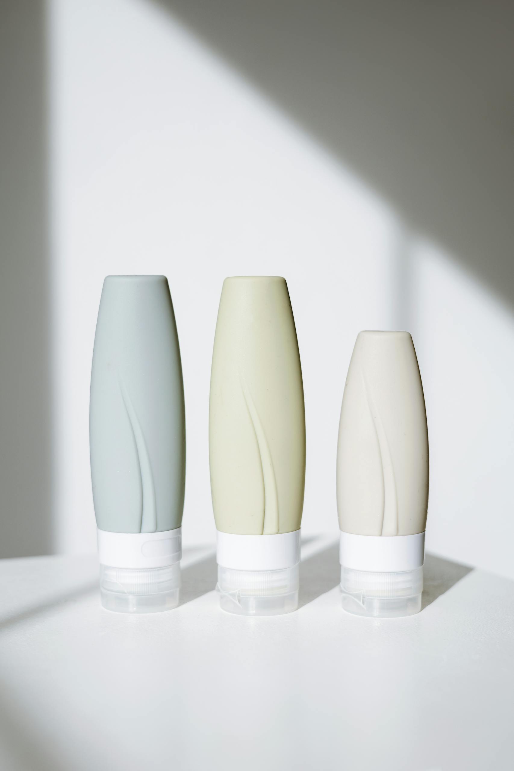 Elegant tubes of skincare products in a minimalist setup with bright lighting.