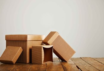 set-three-unlabeled-similar-craft-cardboard-boxes-with-covers-beautifully-arranged-studio-with-white-walls_11zon